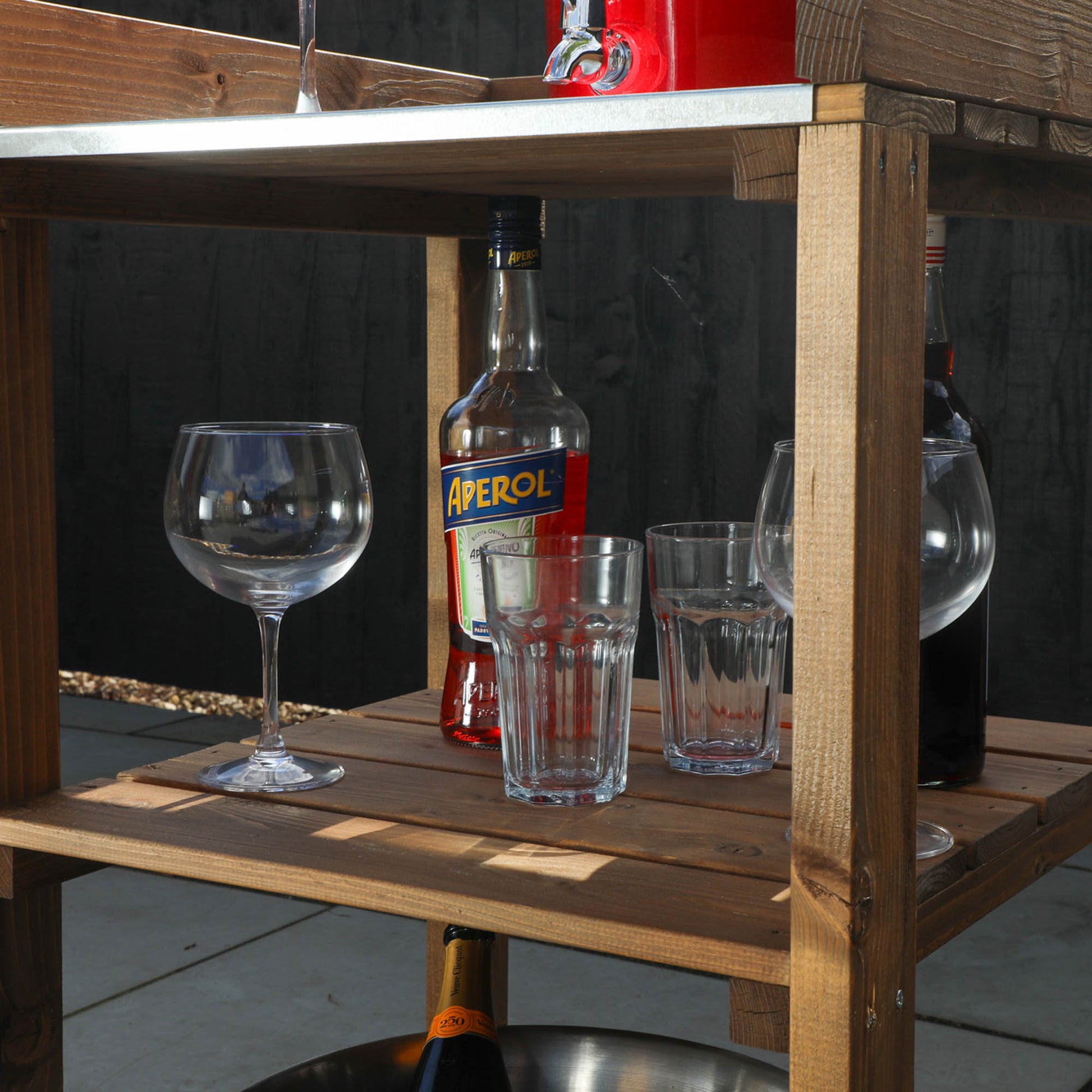 A bright summery drink on a timber outdoor kitchen