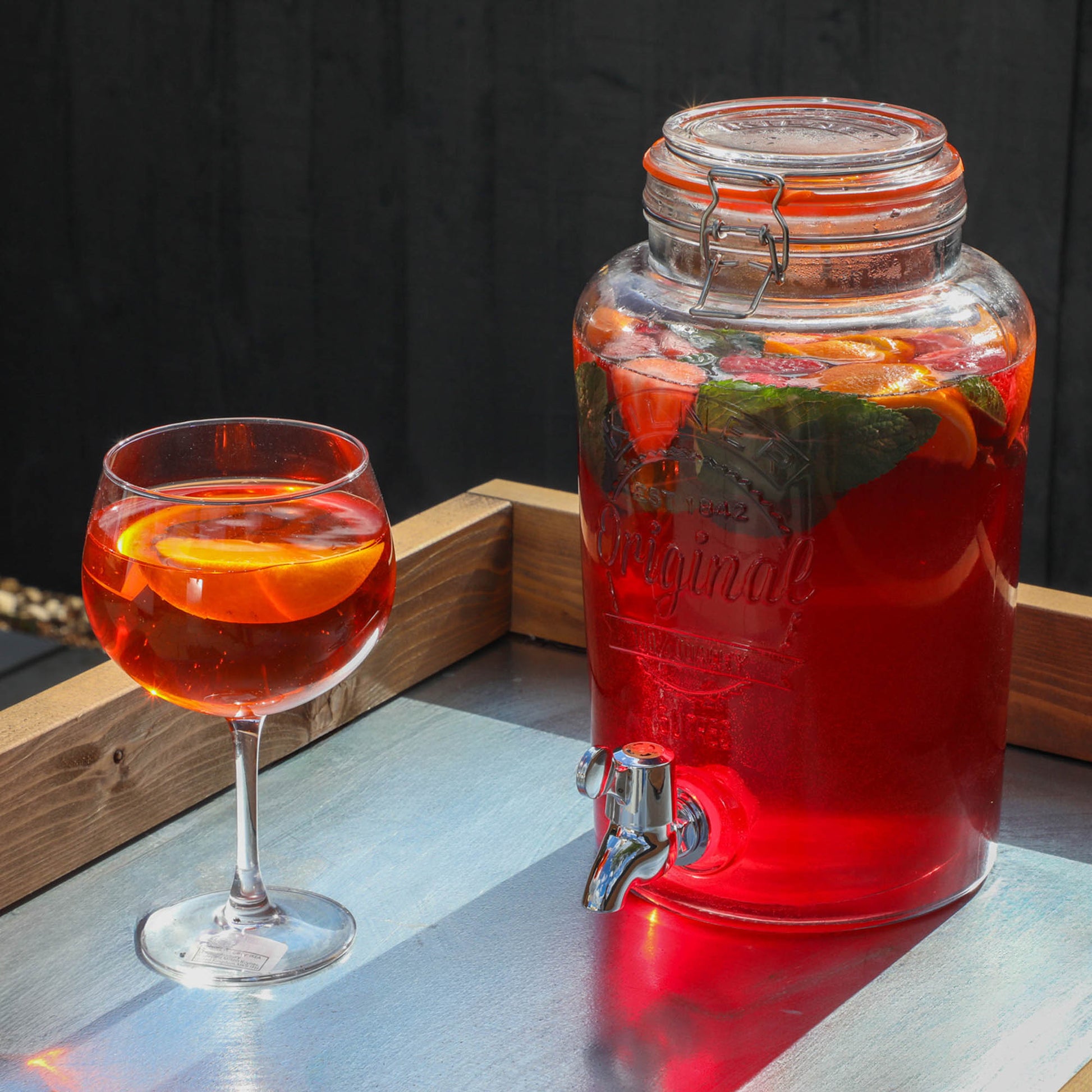 A bright summery drink on a timber outdoor kitchen