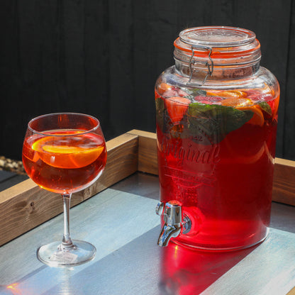 A bright summery drink on a timber outdoor kitchen