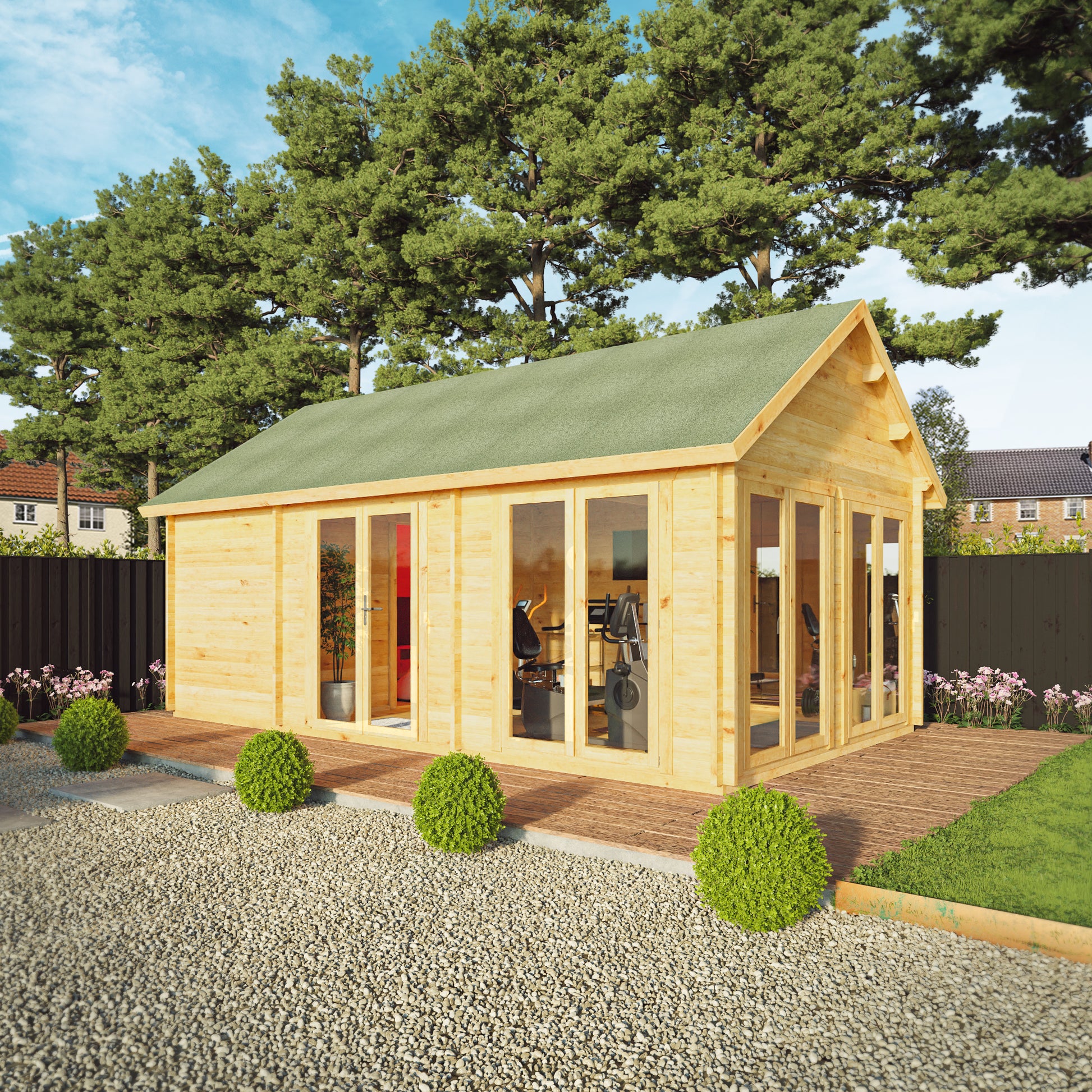 Large timber log cabin, with apex roof, full length windows, double doors in a modern garden. Being used as a home gym and computer gaming room.